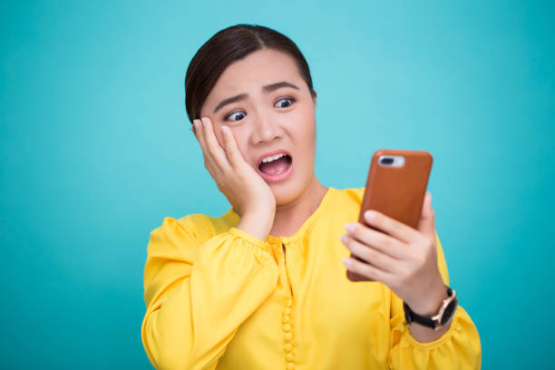 istock Woman look at smartphone and she shocked 658449018
