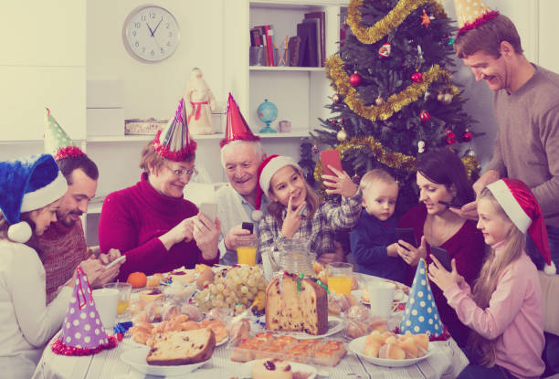 istock Large family making numerous photos during Christmas dinner 658449084