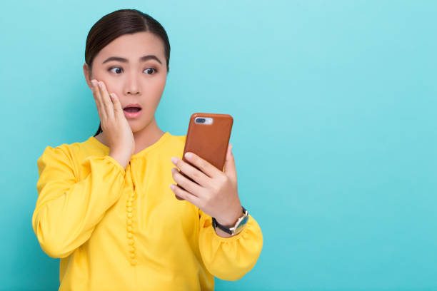 istock Woman look at smartphone and she shocked 658449104