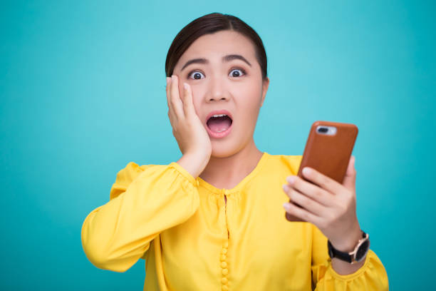 istock Woman look at smartphone and she shocked 658449164