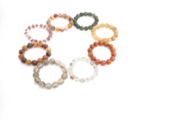 istock Beautiful translucent assorted colors Rutilated Quartz or Venus' hairstone bead in bracelets on white background 658455486