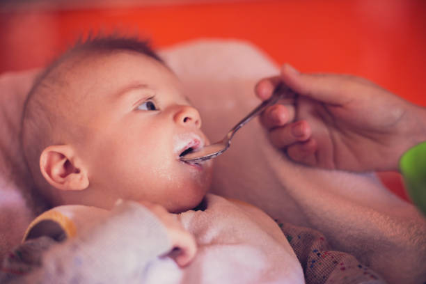istock Young caring father feeding a cute baby boy 658455526