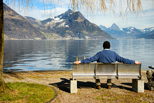 Man on a bench by lake