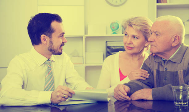 istock Woman and eldery man with bank employee 658458142