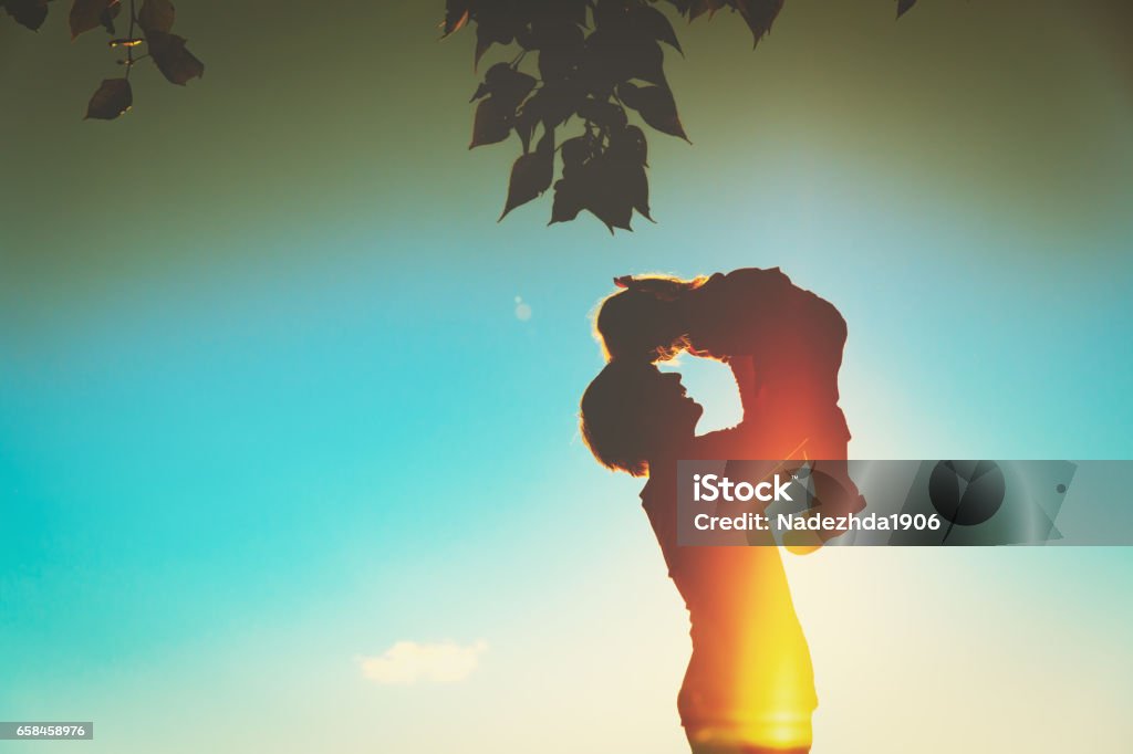 Father and little daughter silhouettes play at sunset happy father and little daughter silhouettes play at sunset Adult Stock Photo