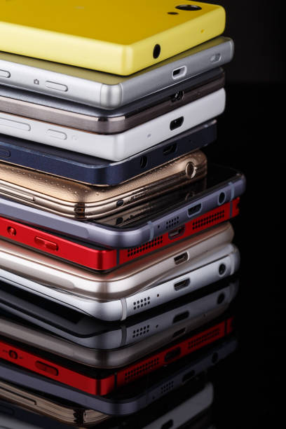 Heap of electronical devices close up - smartphones on black background