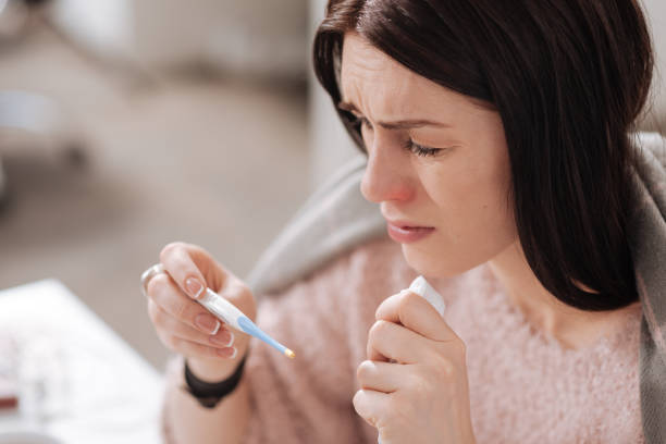 istock Portrait of sick girl while controlling her temperature 658470120