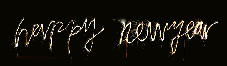 Happy New Year words made by fireworks with black background.