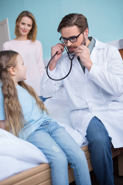 istock Mother and daughter visiting doctor 658473282