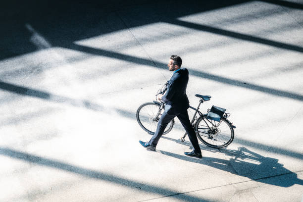 istock bearded elegant businessman going with bycicle in city 658476124