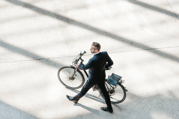 istock overhead view on elegant businessman with bycicle in city 658476202