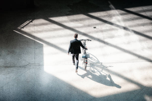 Shot of a young man going for a bicycle ride along the promenade
