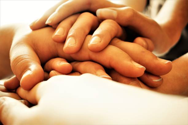 istock hands together one on the other 658477104