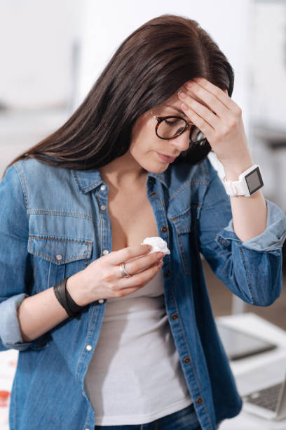 istock Attentive female person touching her forehead 658479346