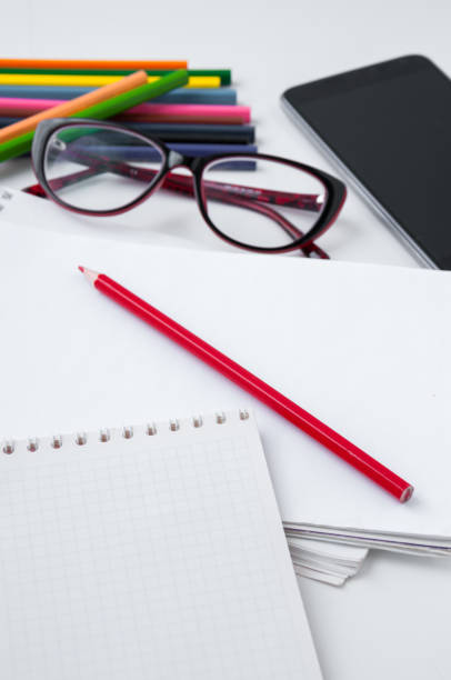 istock Business still-life, glasses, smart phone, notebook and colored pencils 658479744