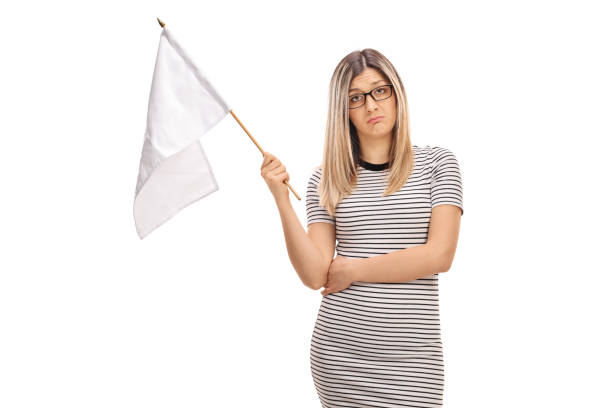 istock Sad young woman holding a white flag 658486924