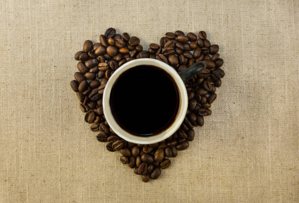 istock Cup with coffee and heart of coffee beanes 658487462