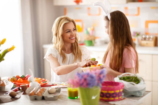 Mother and daughter prepares Easter eggs