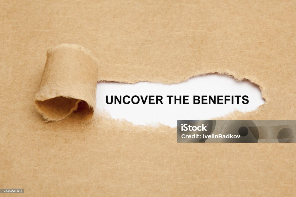 Uncover The Benefits Text Uncover The Benefits appearing behind ripped brown paper. Benefits Stock Photo