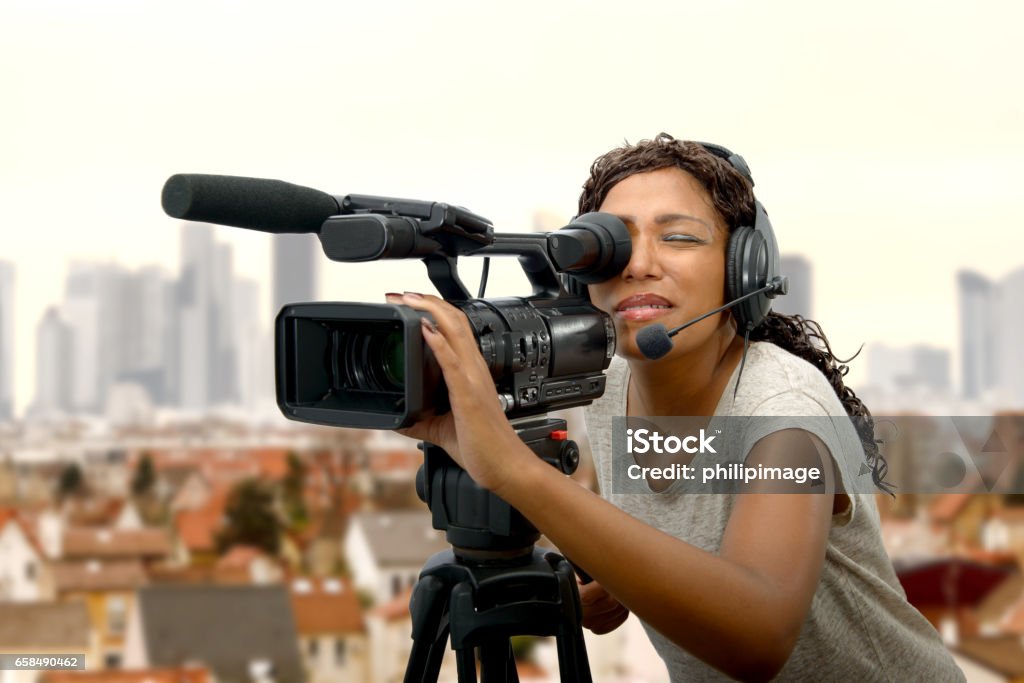 young African American women with professional video camera a young African American women with professional video camera and headphone Camera Operator Stock Photo