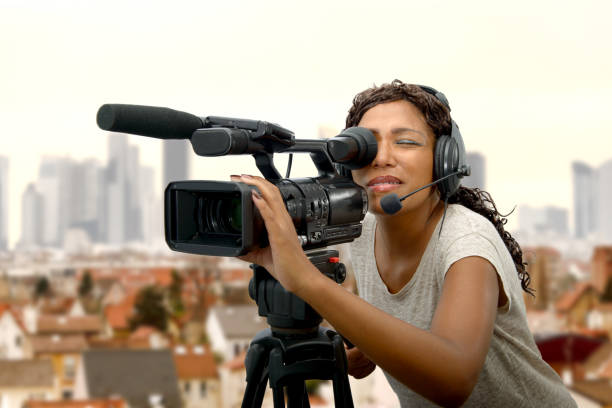 young African American women with professional video camera a young African American women with professional video camera and headphone film crew stock pictures, royalty-free photos & images