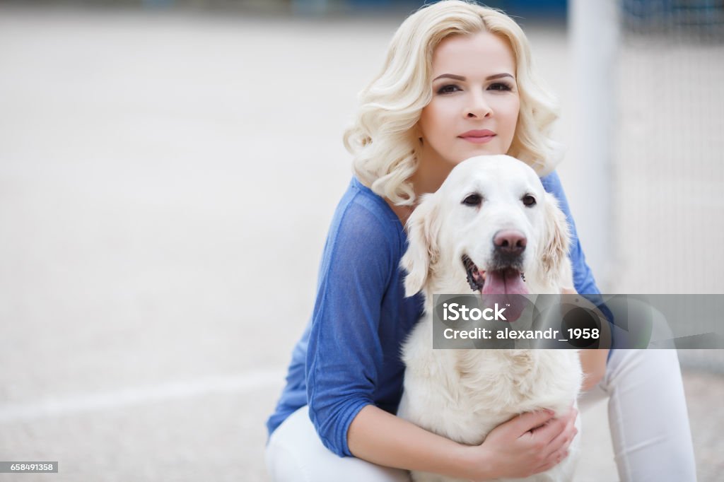 Young Beautiful Blonde With The Dog Breed Golden Retriever Stock Photo -  Download Image Now - iStock