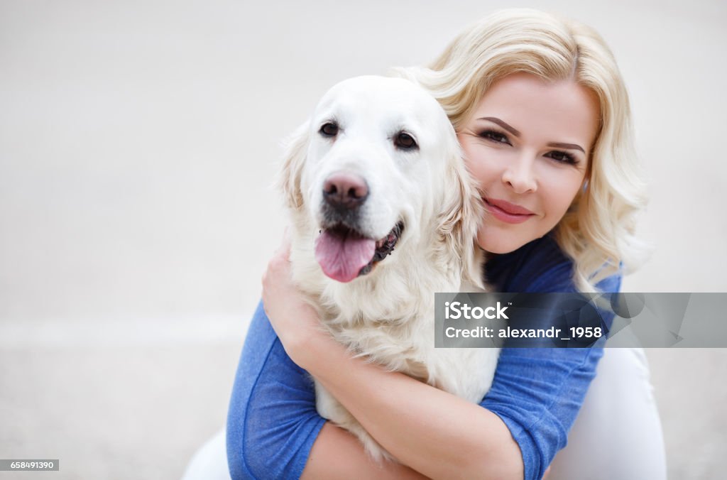 Young Beautiful Blonde With The Dog Breed Golden Retriever Stock Photo -  Download Image Now - iStock