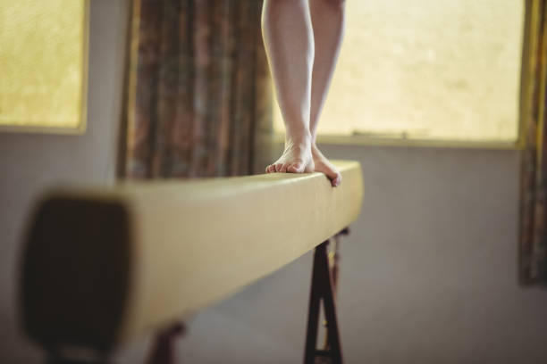 istock Female gymnast practicing gymnastics on the balance beam 658495752