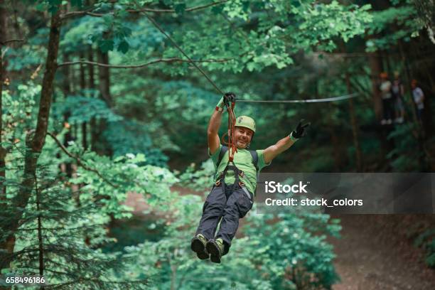 Freedom And Fun Time On Tyrolean Traverse Stock Photo - Download Image Now - Tyrolean Traverse, Men, Rappelling