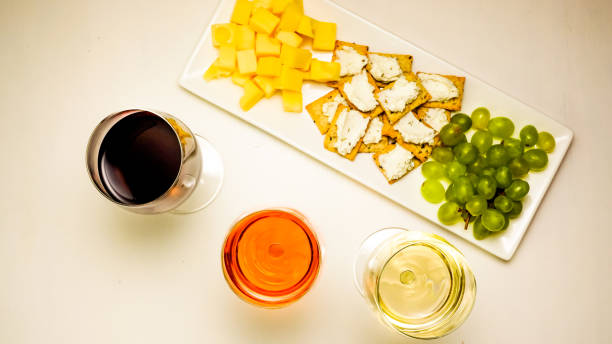 istock Three glasses filled with wine with a snack on a platter 658496828