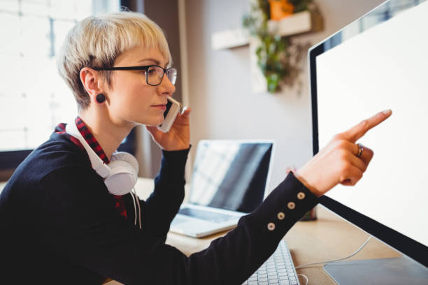 istock Graphic designer discussing her work on mobile phone 658501258