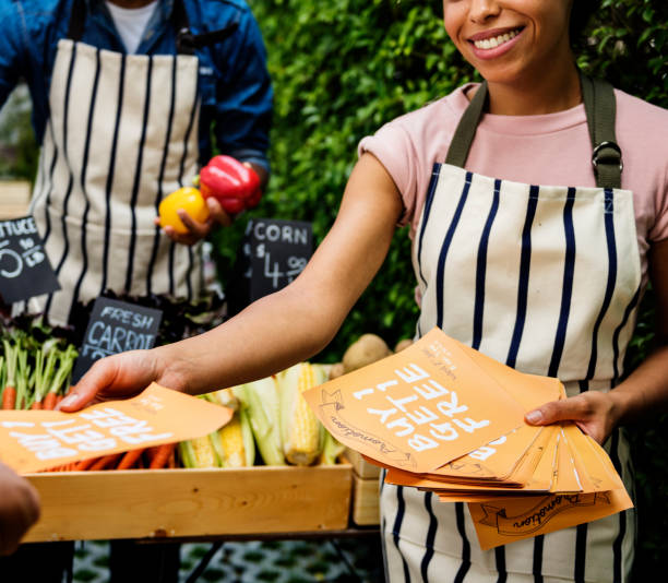 istock People Handing Out Promotion Brochure to Customer 658501764