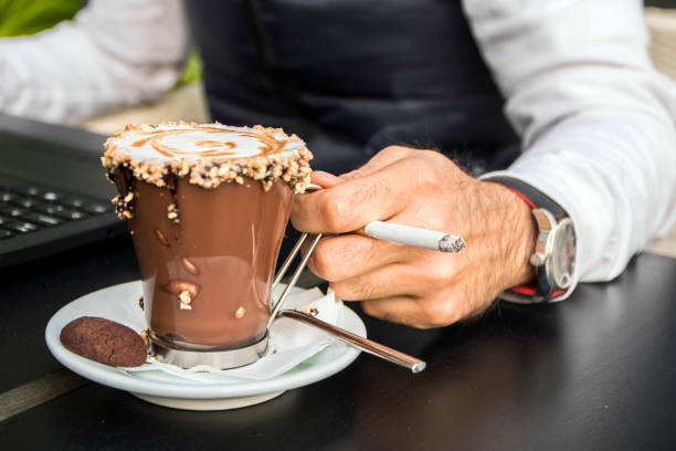 istock Stylish man with laptop, coffee and cigarette. 658502202