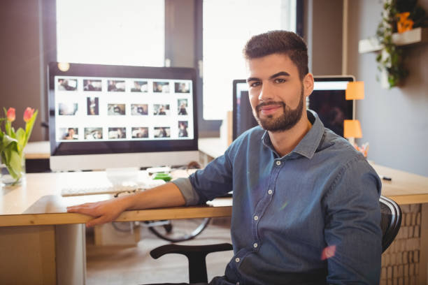 istock Happy graphic designer sitting at office 658502890