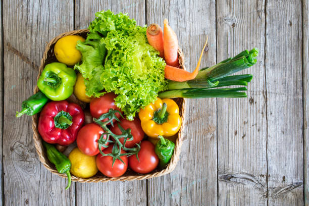 istock Vegetables in basket on wooden table 658505380