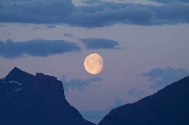 istock Full moon in between mountains in a summer night 658505600