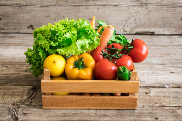 istock Vegetables in basket on wooden table 658505726
