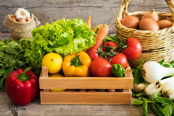 istock Vegetables in basket on wooden table 658505752