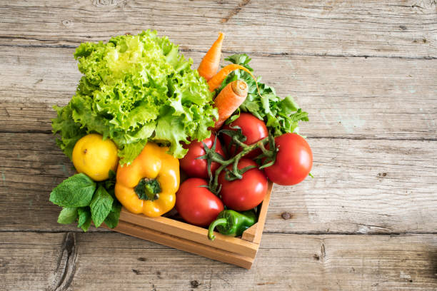 Vegetables in basket on wooden table
