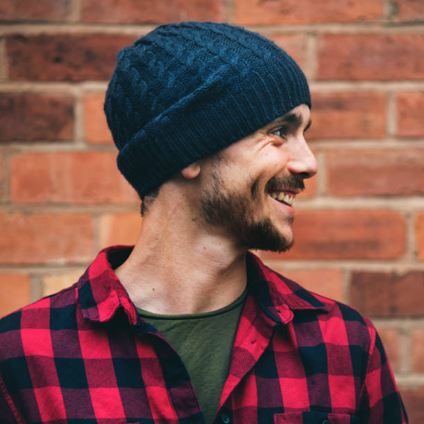 istock Man Beanie Hat Hipster Style Brick Wall Smiling Concept 658509952