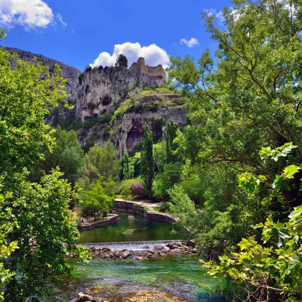 Beautiful Medieval Village Fontaine de Vaucluse and its castle on the river shore, Provence, France.The poet Petrarch made it his preferred residence in the 14th century