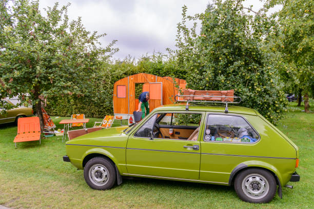 volkswagen golf mark i hatchback car with a caravan - golf bag imagens e fotografias de stock