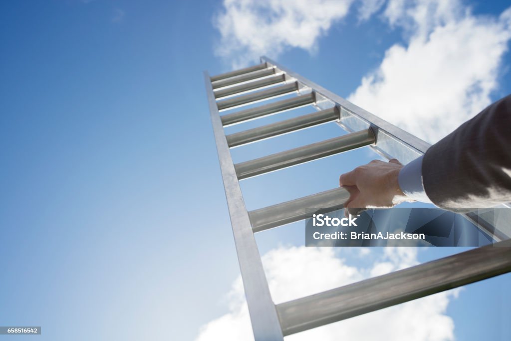 Ladder of success Businessman climbing the corporate ladder of success Ladder Stock Photo