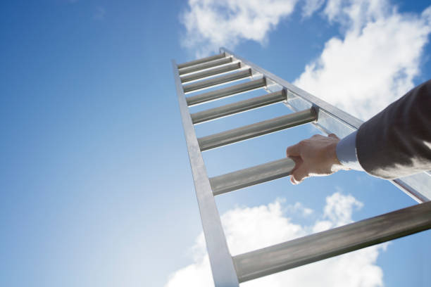 Ladder of success Businessman climbing the corporate ladder of success ladder of success stock pictures, royalty-free photos & images
