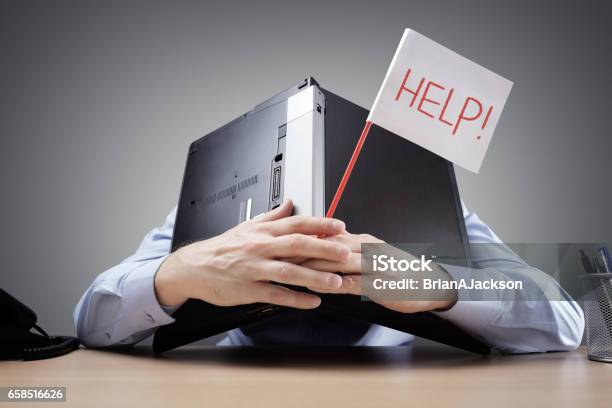 Businessman Burying His Head Uner A Laptop Asking For Help Stock Photo - Download Image Now