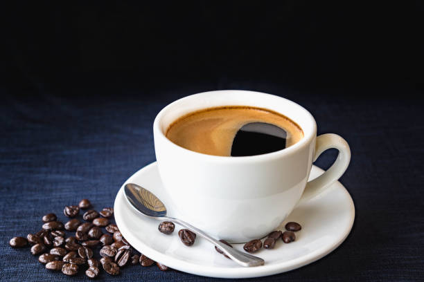 istock Coffee cup and beans on a dark background 658521012