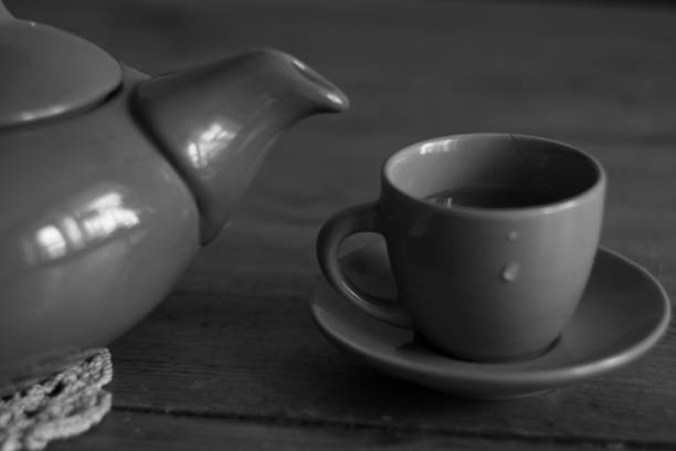 istock Clay tea pot and cup close up in black and hite style 658521328