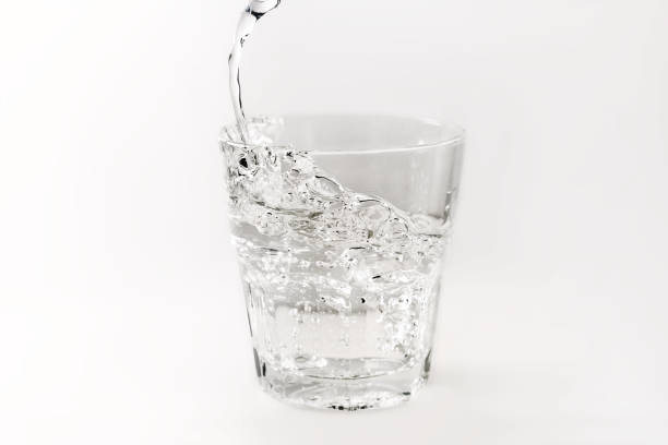 istock Pour water into a isolated glass on a white background 658521818