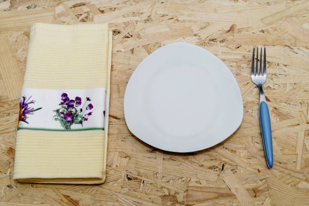 istock Towel, plate and fork on the natural wood table 658521830
