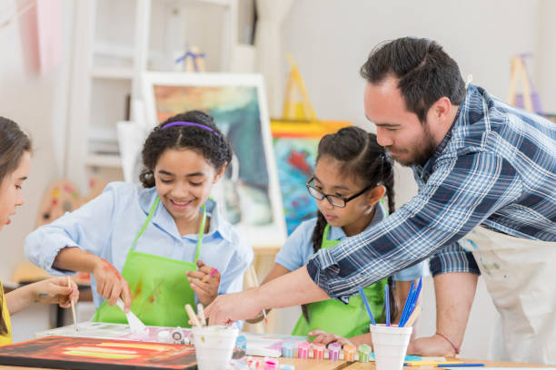 istock Male art teacher with works with students 658527184
